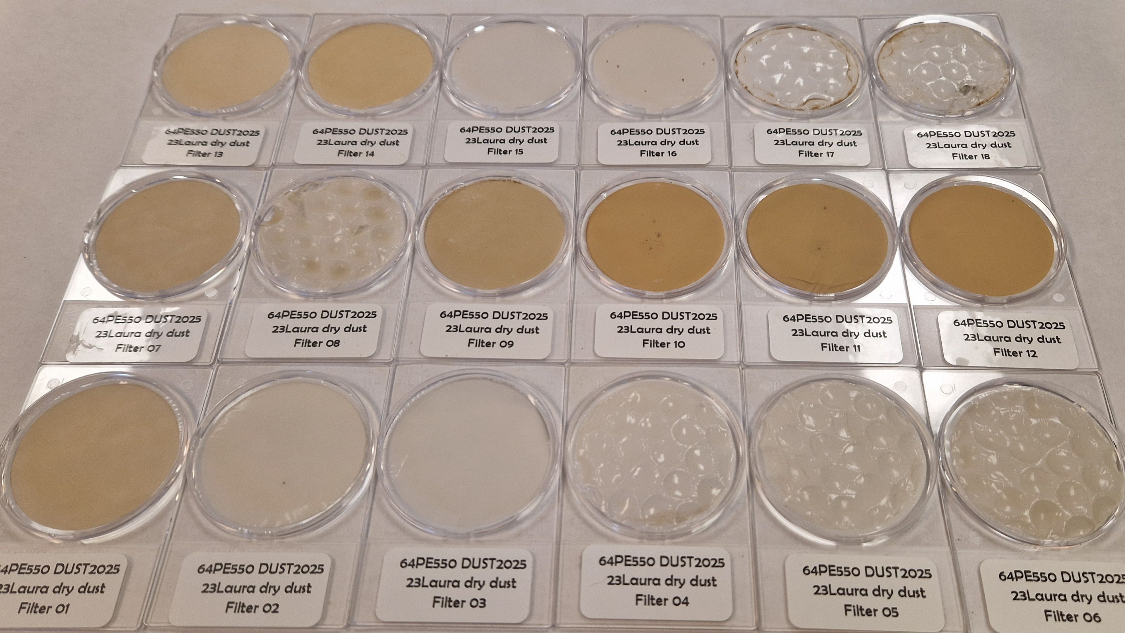 12 samples of dust in round glass trays