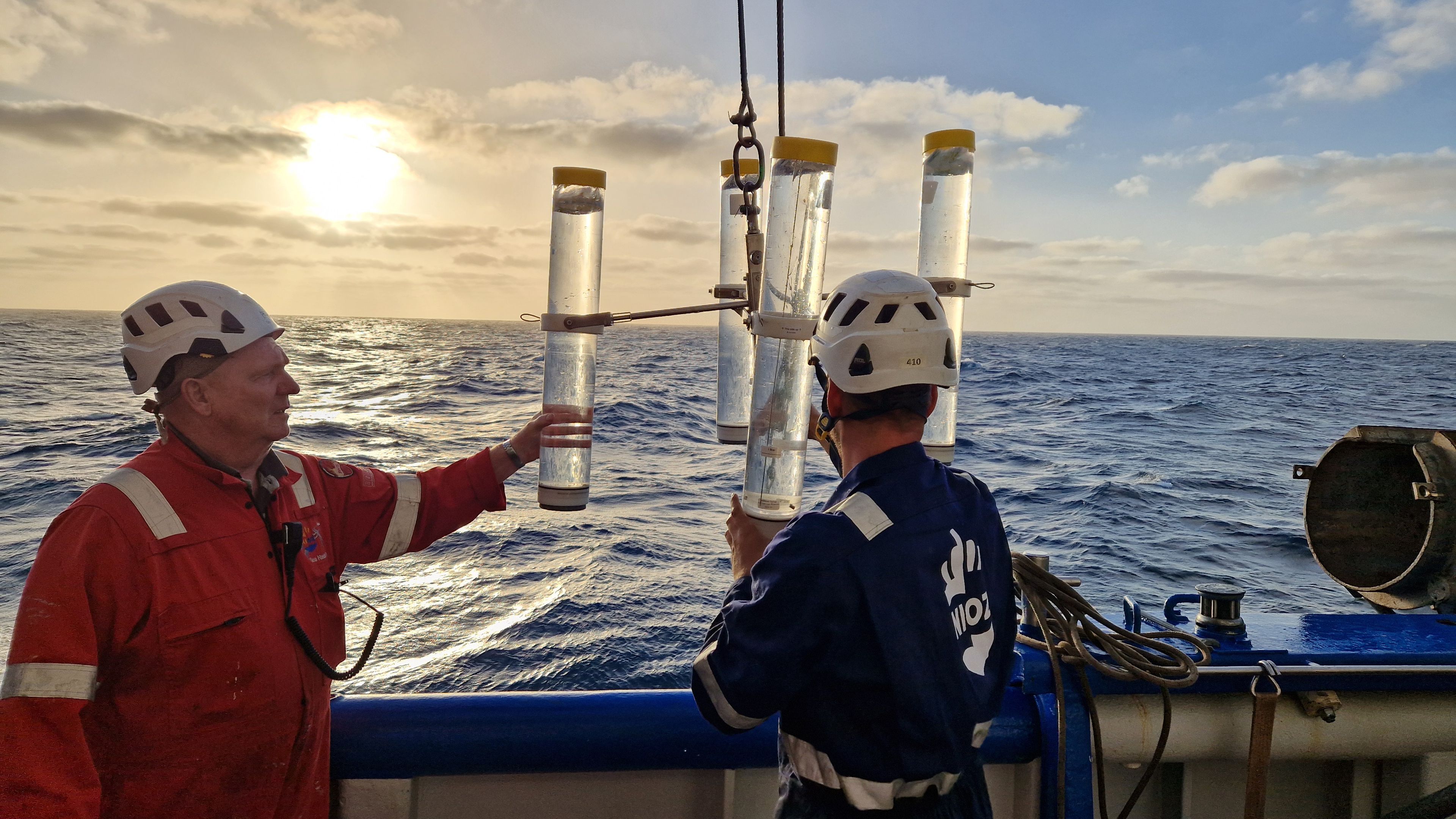 Two men on board of a research vessel with 4 drifting traps