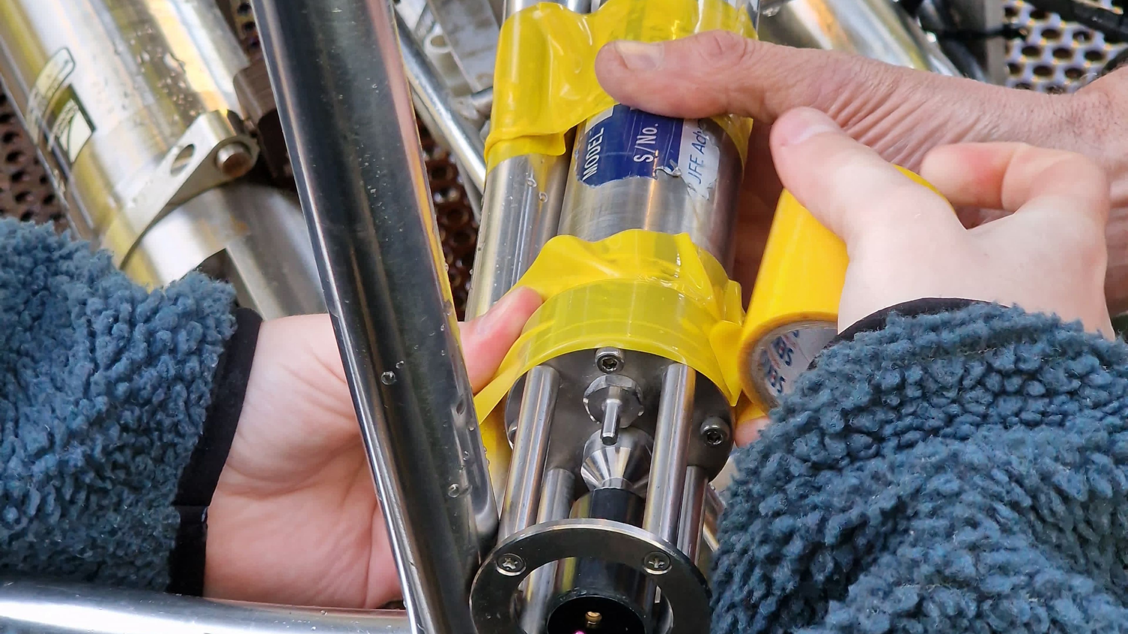 Close-up photo of hands with a research instrument