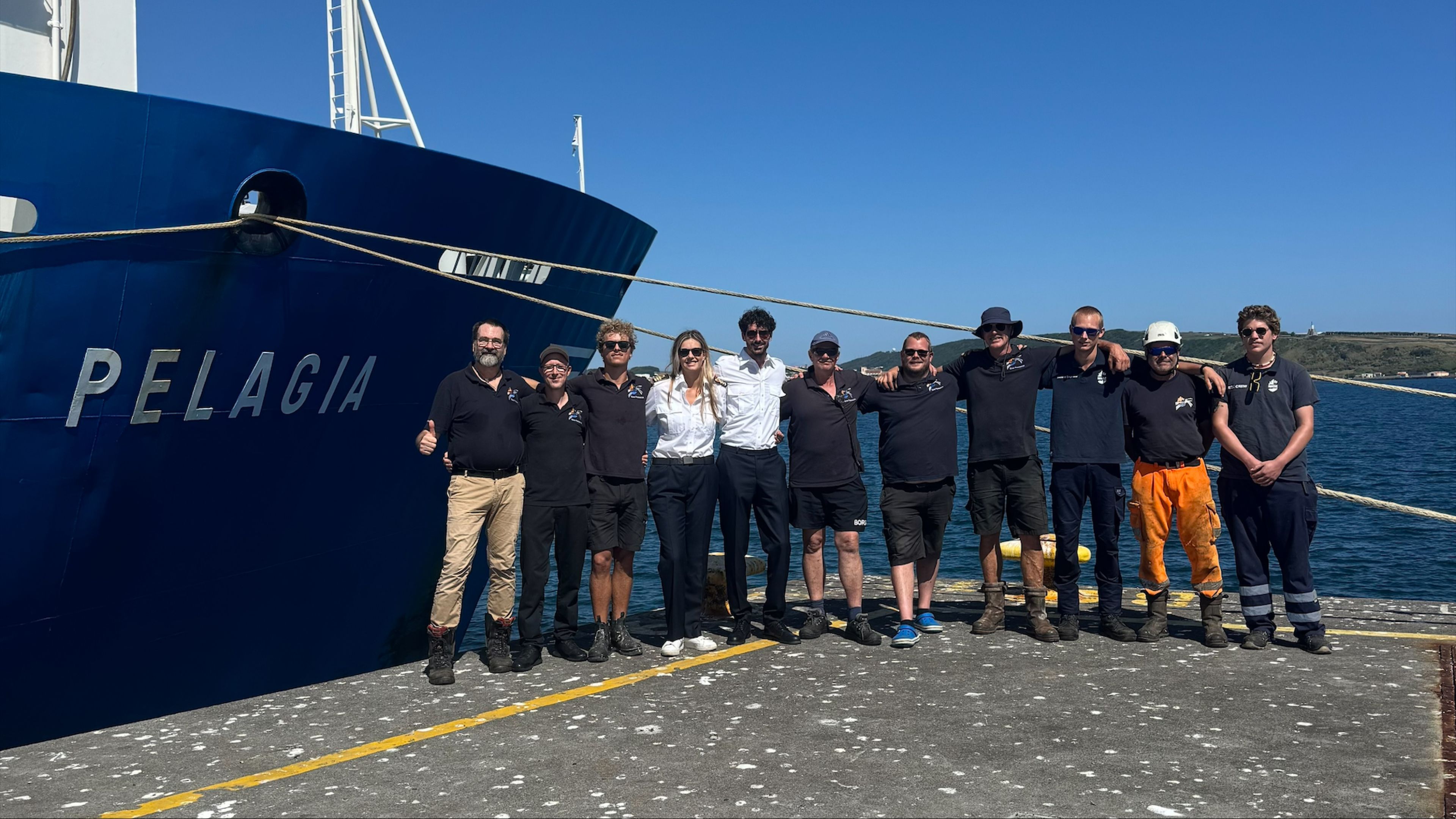 Photo of crew in front of research vessel Pelagia